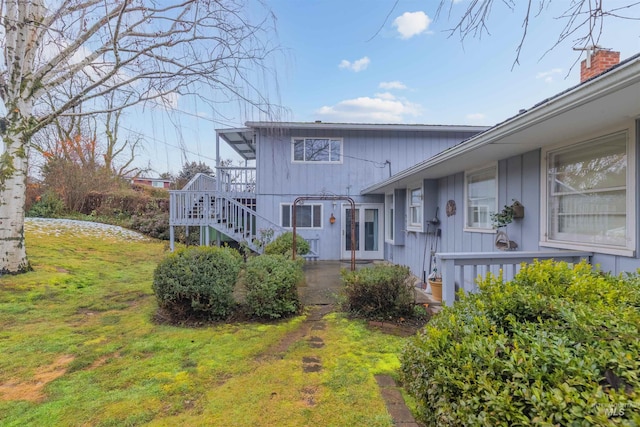 exterior space with a front yard and stairway