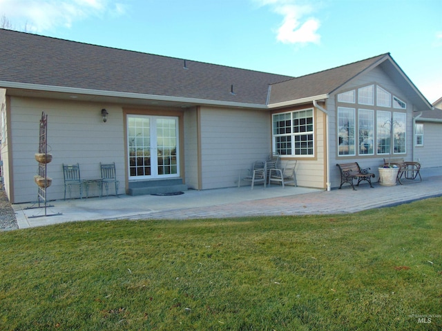 back of house featuring a patio area and a yard