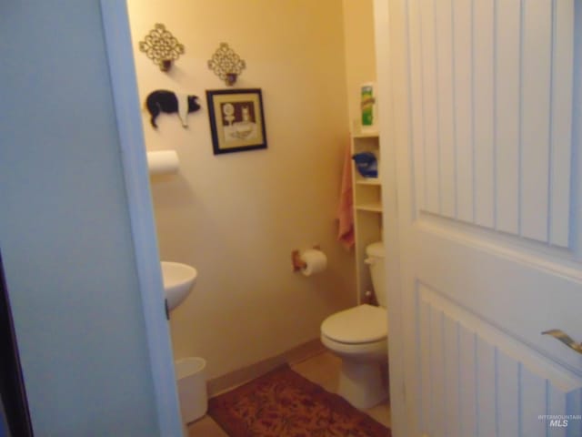 bathroom featuring toilet and tile patterned floors