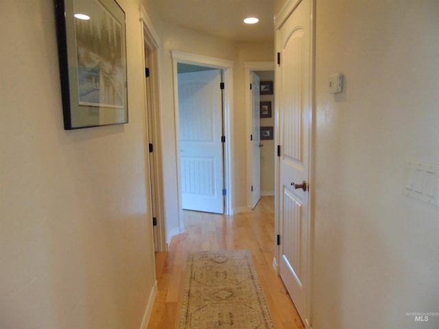 corridor with light hardwood / wood-style flooring