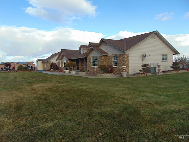 exterior space with a front lawn and cooling unit