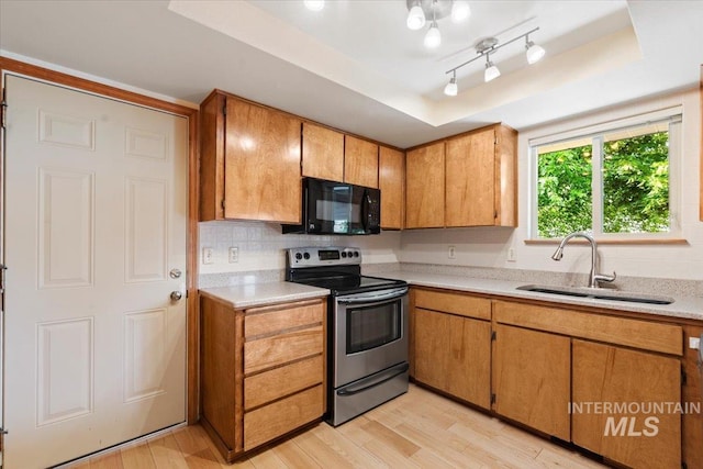 3493 N Buckboard Way, Boise, ID 83713 - kitchen featuring stainless steel range with electric cooktop, black microwave, a tray ceiling, light countertops, and light wood-style flooring