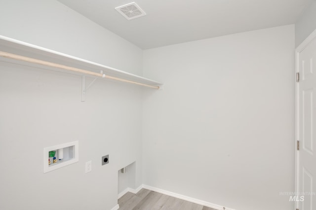 laundry area featuring visible vents, light wood finished floors, hookup for an electric dryer, hookup for a washing machine, and laundry area