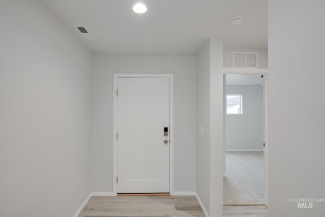 entryway with visible vents, baseboards, and light wood-style floors