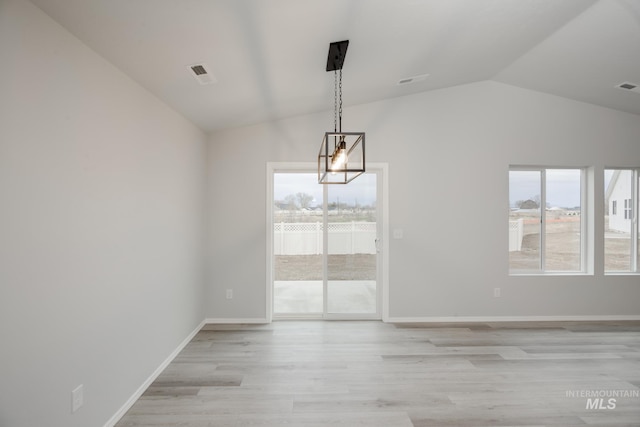 unfurnished dining area with lofted ceiling, a healthy amount of sunlight, light wood-style floors, and baseboards