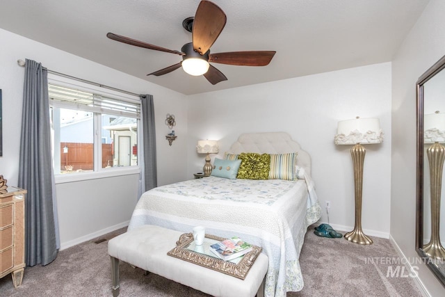 carpeted bedroom featuring ceiling fan and baseboards