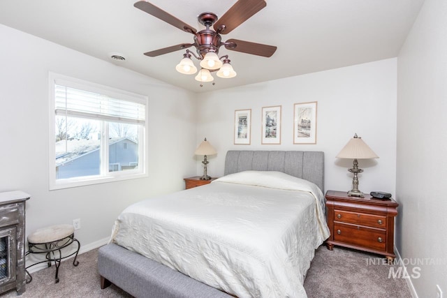 carpeted bedroom with visible vents, ceiling fan, and baseboards