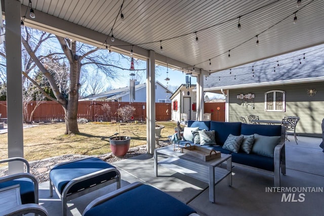 view of patio featuring fence and an outdoor hangout area