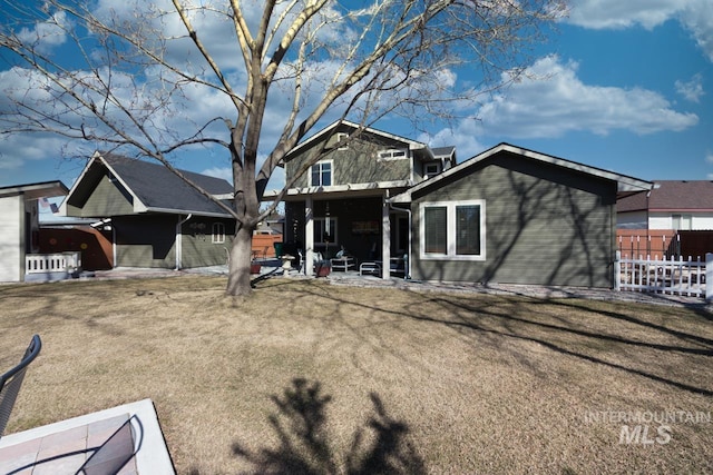 view of front of house with a patio area and fence