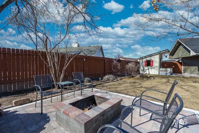 view of patio featuring a fenced backyard and a fire pit