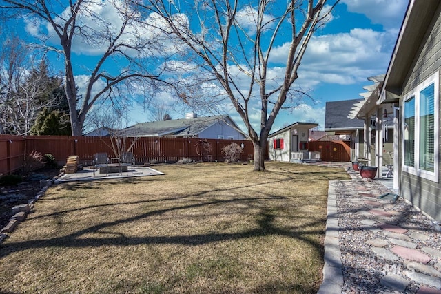 view of yard with an outdoor fire pit, a patio area, and a fenced backyard