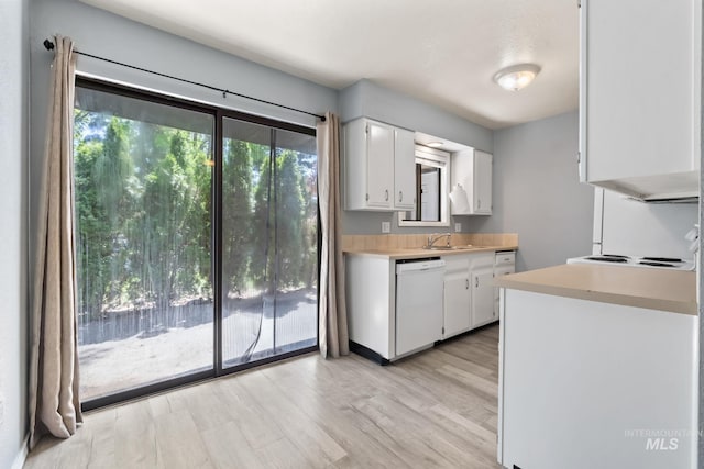 kitchen with light countertops, white cabinetry, a sink, and dishwasher