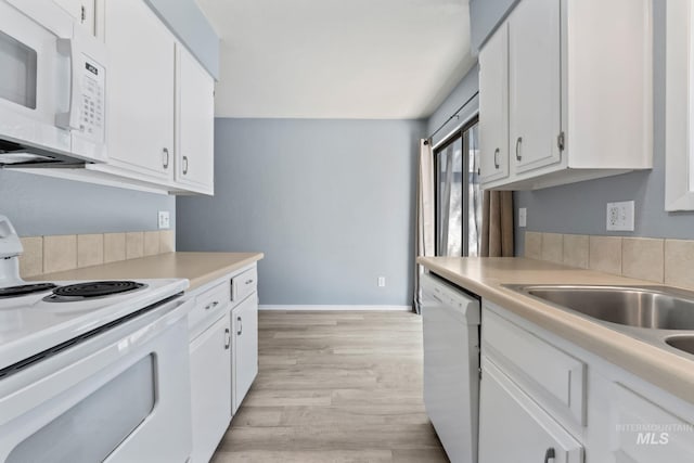 kitchen featuring light wood-style flooring, white cabinetry, and white appliances