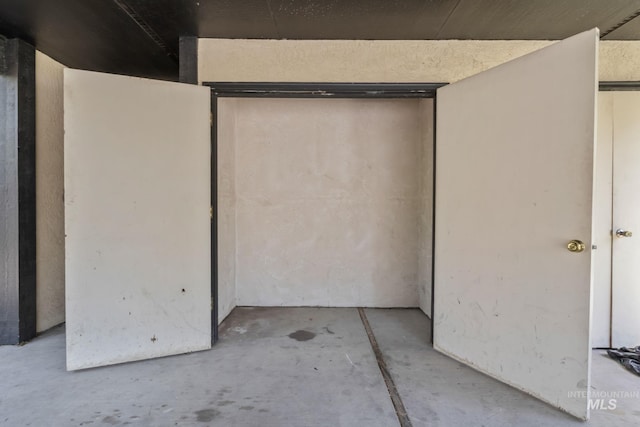 interior space with concrete floors and a closet