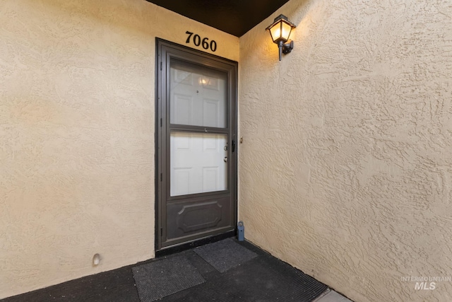 view of exterior entry with stucco siding