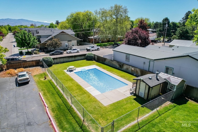 view of pool with a fenced in pool, a fenced backyard, a mountain view, and a residential view