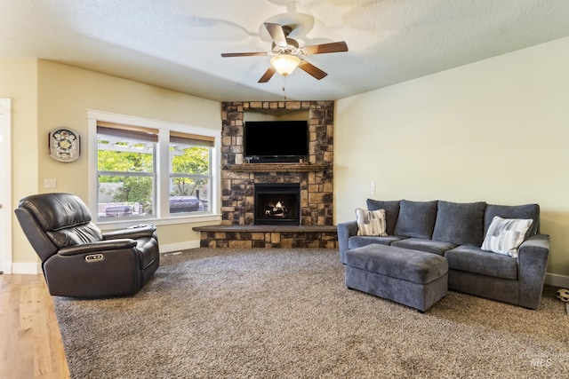 2310 W Herron Loop, Nampa, ID 83686 - carpeted living area featuring ceiling fan, a stone fireplace, and a textured ceiling