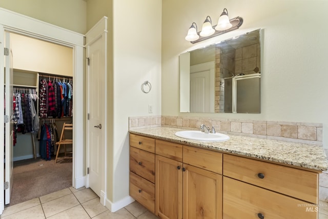 2310 W Herron Loop, Nampa, ID 83686 - bathroom featuring a shower stall, vanity, tile patterned floors, and a walk in closet