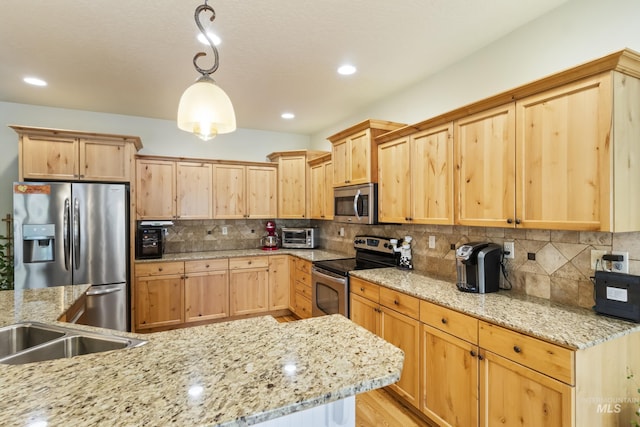 2310 W Herron Loop, Nampa, ID 83686 - kitchen featuring appliances with stainless steel finishes, light brown cabinets, tasteful backsplash, and recessed lighting