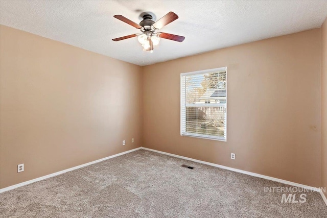 unfurnished room with ceiling fan, carpet floors, and a textured ceiling