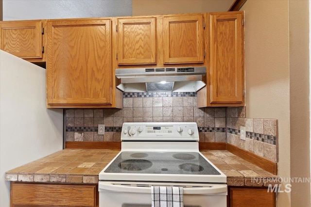 kitchen with tasteful backsplash and white appliances