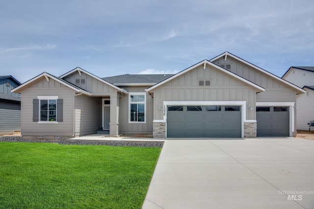 view of front of home featuring an attached garage, a front lawn, board and batten siding, and concrete driveway