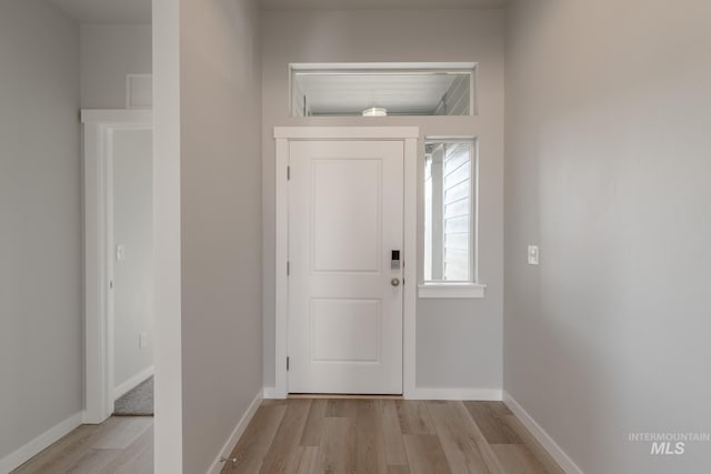 entryway featuring light wood finished floors, visible vents, and baseboards