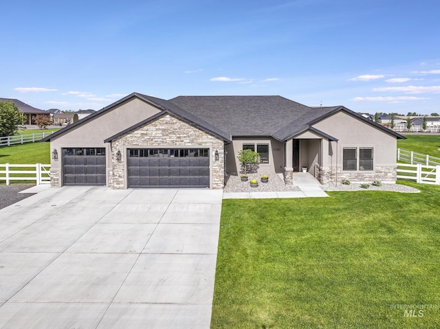 3741 N 2481 E, Twin Falls, ID 83301 - view of front of home featuring stone siding, an attached garage, stucco siding, concrete driveway, and roof with shingles