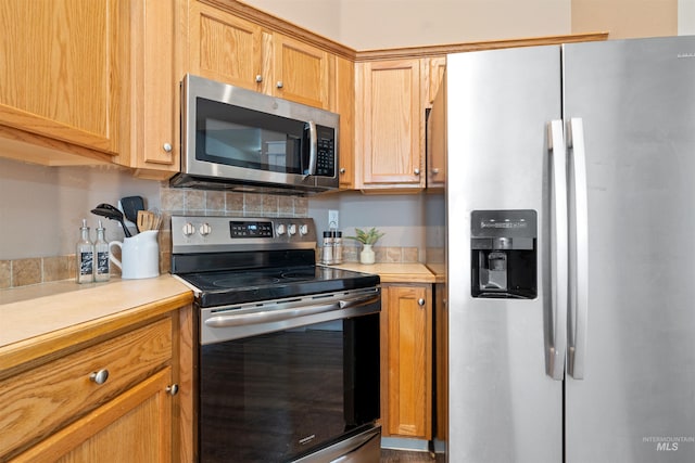 kitchen with stainless steel appliances, light countertops, and tasteful backsplash