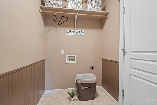 laundry room featuring laundry area, light tile patterned floors, wainscoting, hookup for an electric dryer, and washer hookup