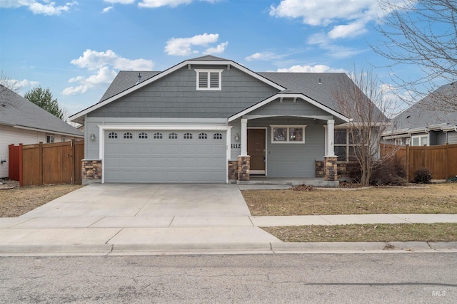 craftsman-style home featuring a shingled roof, concrete driveway, fence, and an attached garage