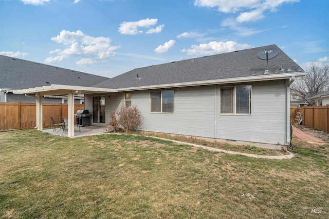 rear view of house featuring a shingled roof, a fenced backyard, crawl space, a yard, and a patio area