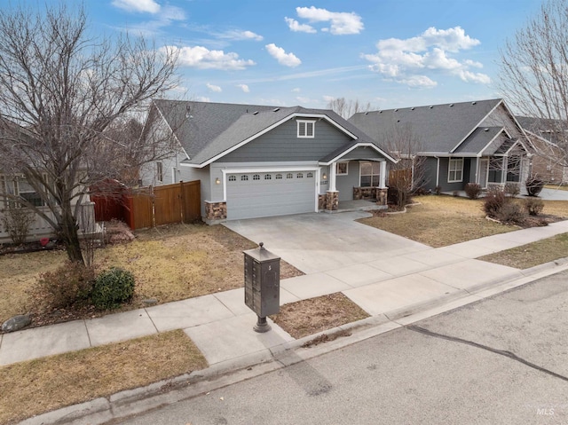 view of front of house featuring a garage, stone siding, fence, and concrete driveway