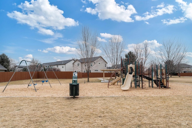 community play area featuring fence and a lawn