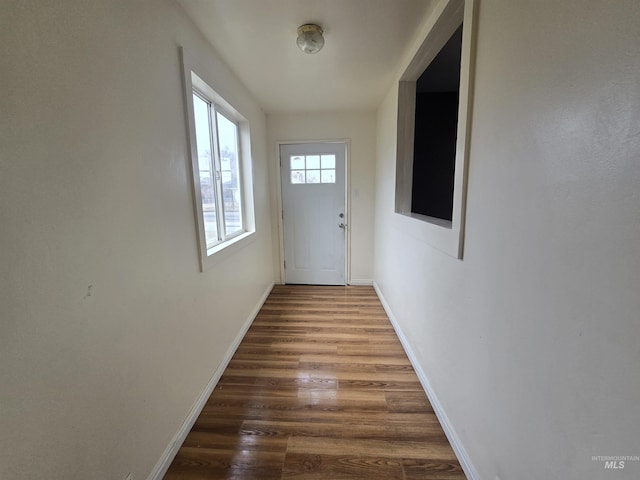 entryway with baseboards and dark wood-style flooring