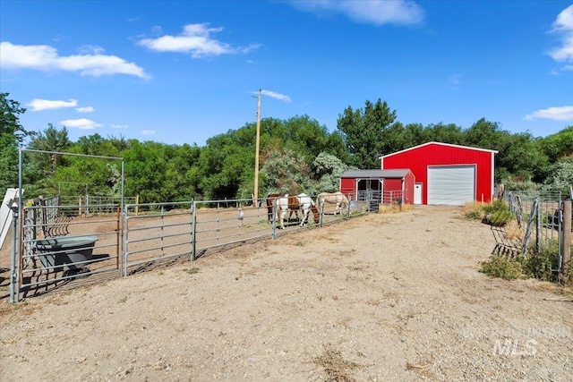 15916 Hill Top Cir, Wilder, ID 83676 - view of yard featuring an outbuilding, a garage, and an exterior structure