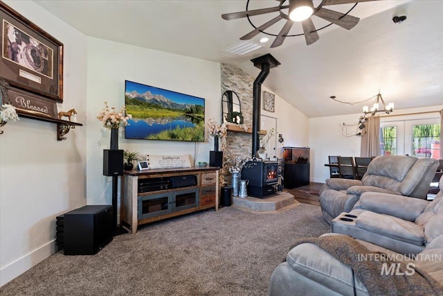 15916 Hill Top Cir, Wilder, ID 83676 - living area featuring a wood stove, ceiling fan, vaulted ceiling, carpet floors, and a chandelier