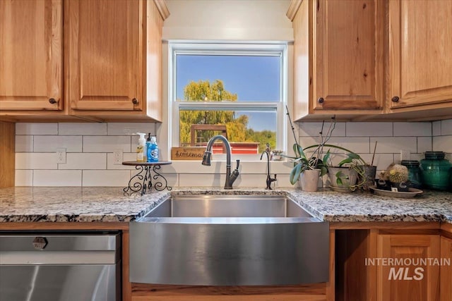 15916 Hill Top Cir, Wilder, ID 83676 - kitchen with stainless steel dishwasher, tasteful backsplash, and light stone counters