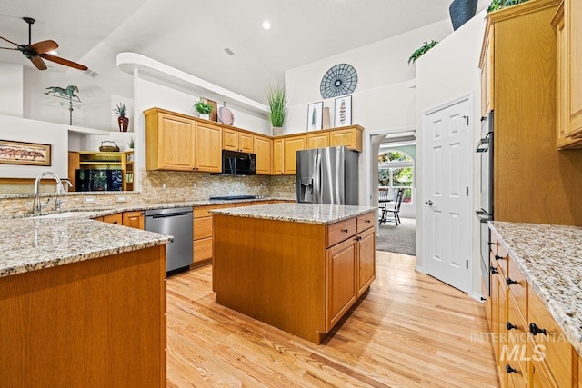 kitchen with black appliances, a ceiling fan, high vaulted ceiling, light wood-style flooring, and a sink