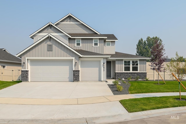 craftsman inspired home featuring a front yard and a garage