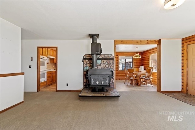 2974 Ua Ave, Emmett, ID 83617 - living room with log walls, a wood stove, and light carpet