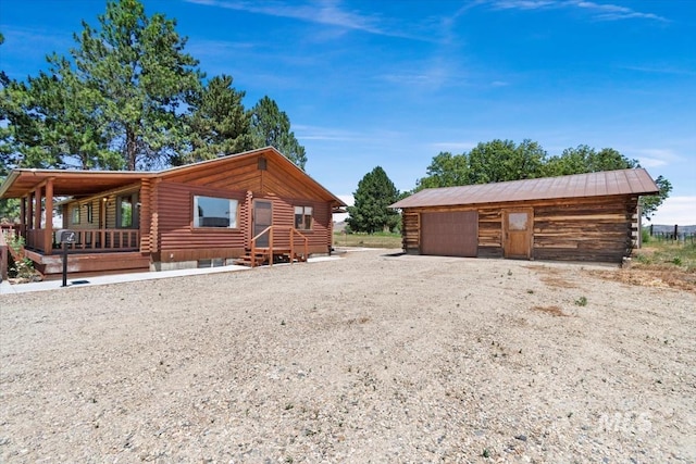 2974 Ua Ave, Emmett, ID 83617 - view of side of property with log siding, a garage, and an outbuilding