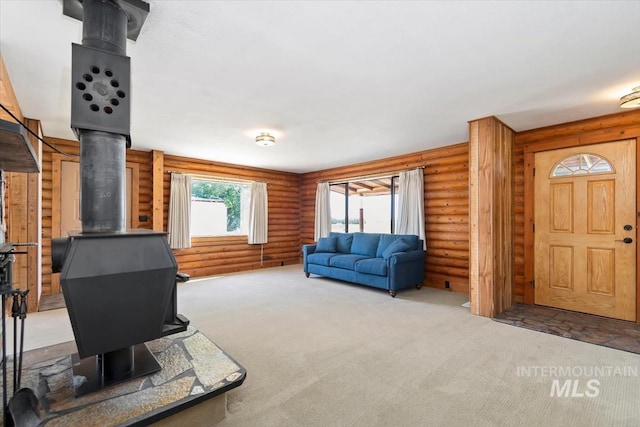 2974 Ua Ave, Emmett, ID 83617 - carpeted living room featuring a wood stove and log walls