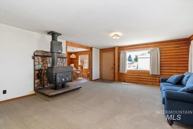 2974 Ua Ave, Emmett, ID 83617 - living area featuring a wood stove, log walls, and light colored carpet