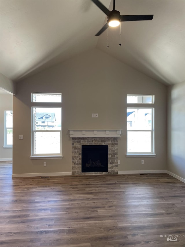 unfurnished living room with plenty of natural light, a fireplace, and wood finished floors