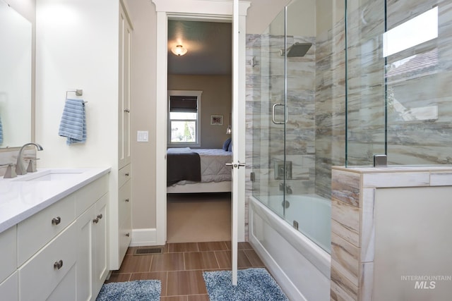 full bathroom featuring vanity, bath / shower combo with glass door, ensuite bath, tile patterned flooring, and visible vents