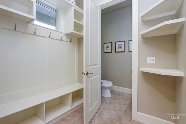mudroom featuring baseboards and light tile patterned floors