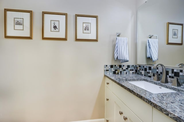 bathroom featuring tasteful backsplash and vanity