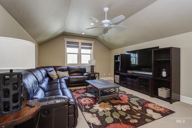 carpeted living area with lofted ceiling, a ceiling fan, and baseboards