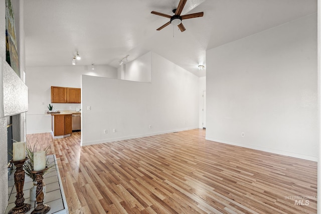 81 N Mirage St, Nampa, ID 83651 - unfurnished living room with lofted ceiling, light wood-type flooring, baseboards, a fireplace, and ceiling fan
